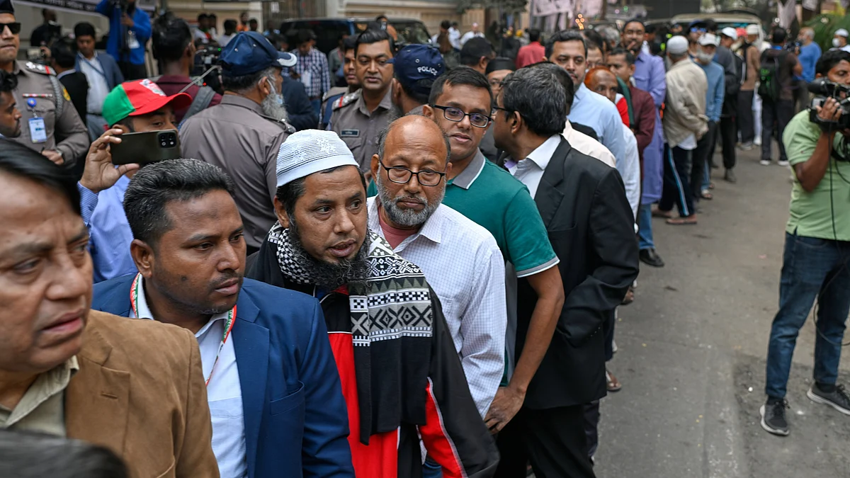 Voters queue outside a polling station in Dhaka.