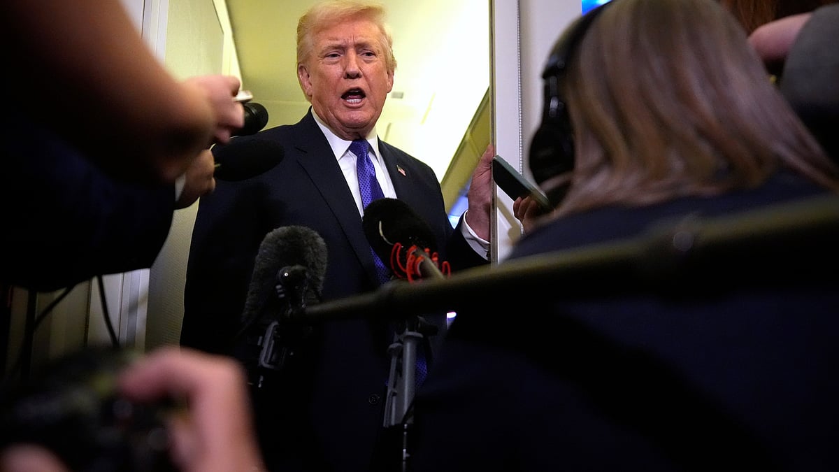 Donald Trump addresses reporters aboard Air Force One.