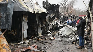 Residents survey the wreckage of a city market after a Russian strike in Ukraine.