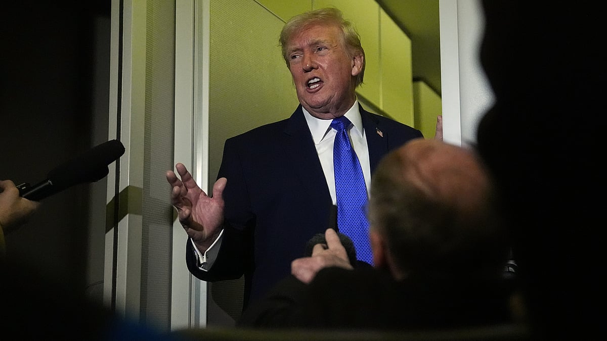 Donald Trump speaks to reporters aboard Air Force One during a flight.