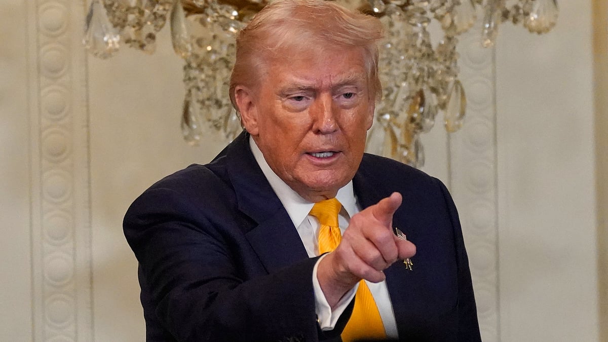 Donald Trump gestures at a Black History Month event in the East Room of the White House.