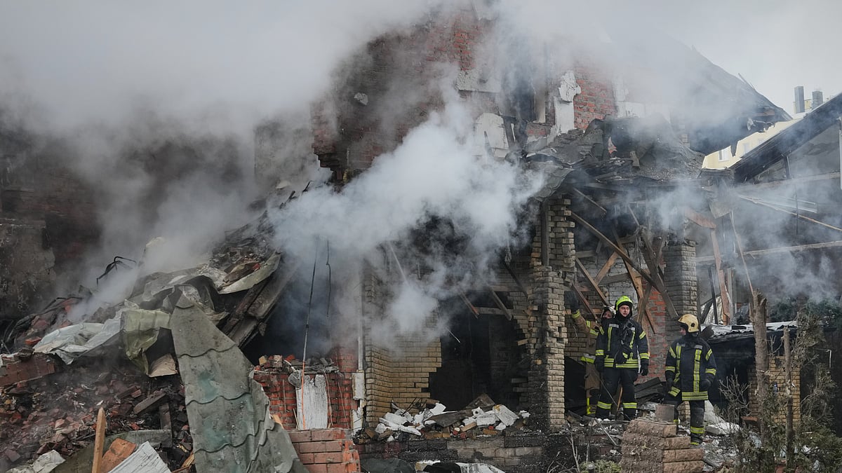 Firefighters extinguish flames after a Russian drone strike hit a residential building in Kyiv.