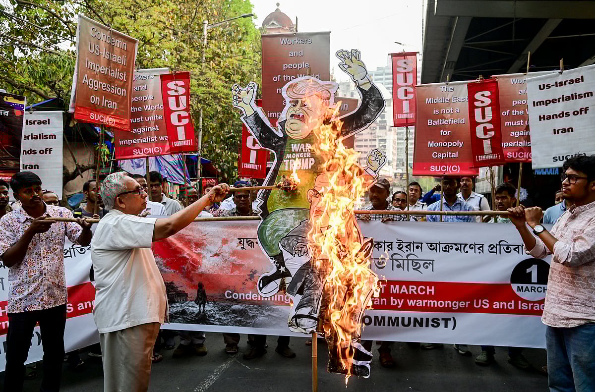 Members of the Socialist Unity Centre of India (Communist) burn an effigy during a protest condemning the US-Israel attack on Iran, in Kolkata, West Bengal.
