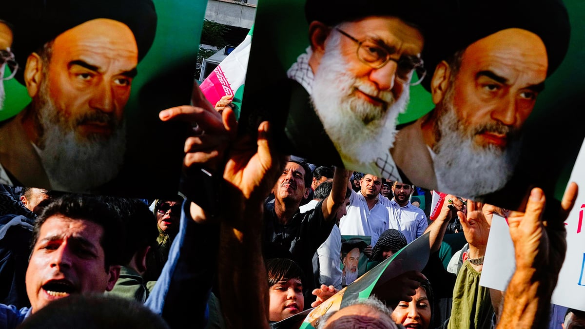 File photo of protesters with posters of Ayatollah Ali Khamenei