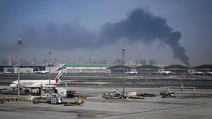 Smoke from an Iranian strike forms the backdrop to Dubai International Airport after its closure, 1 March