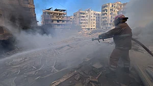 A firefighter extinguishes fire at a building that was hit by an Israeli airstrike in Beirut, Lebanon.