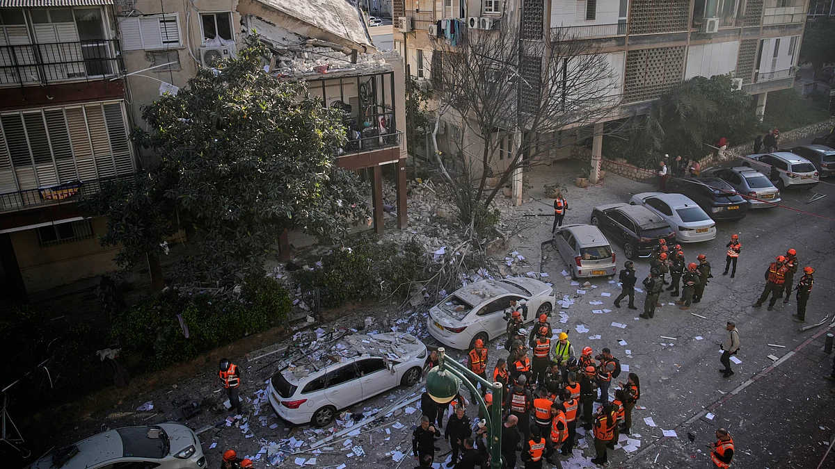 Officers from Israel’s Home Front Command inspect a damaged apartment building in Ramat Gan.