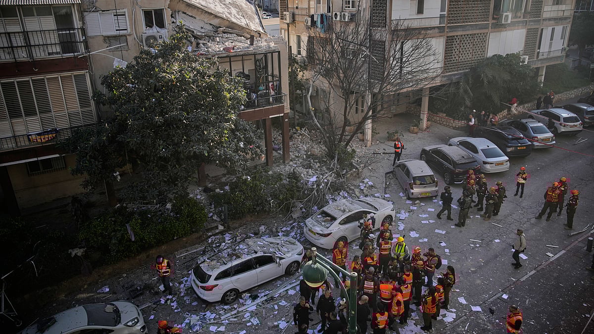 Officers from Israel’s Home Front Command inspect a damaged apartment building in Ramat Gan.