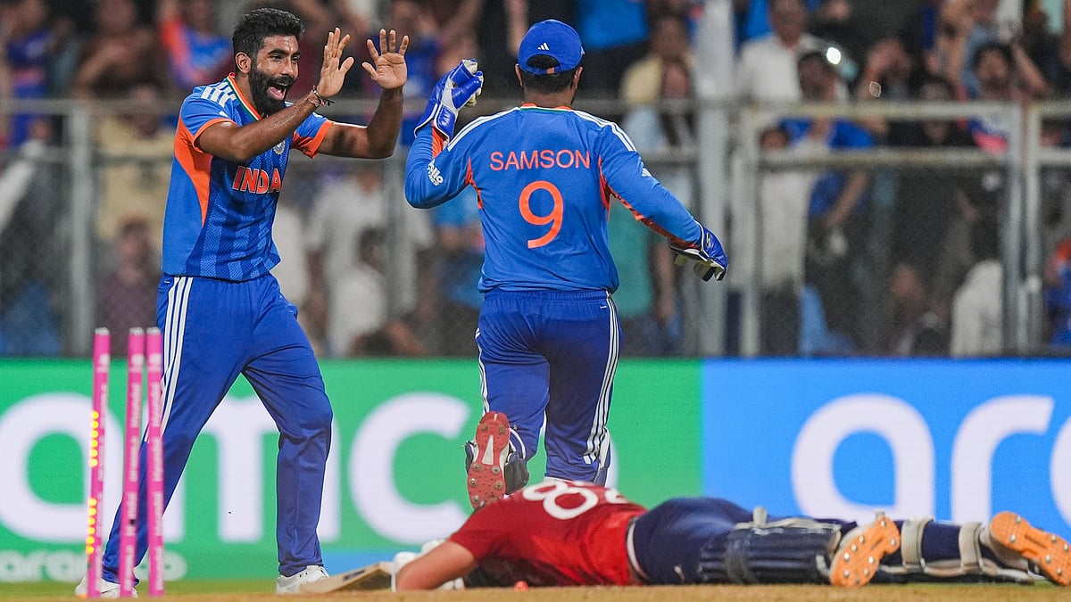 Bumrah and Samson celebrate Jacob Bethell’s dismissal at Wankhede Stadium, Mumbai.