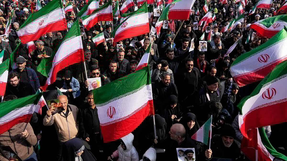 People hold Iranian flags during a protest in Tehran.