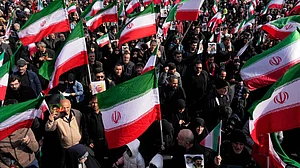 People hold Iranian flags during a protest in Tehran.