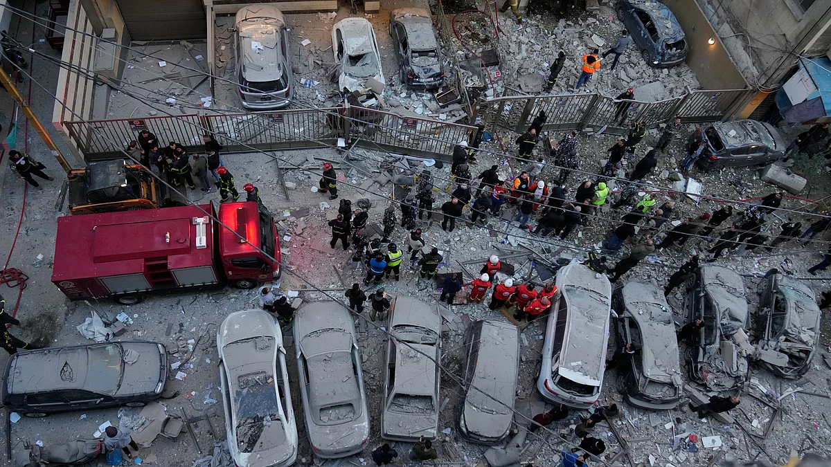 Rescue workers gather at the site where Israeli airstrikes hit apartments in Beirut, Lebanon.