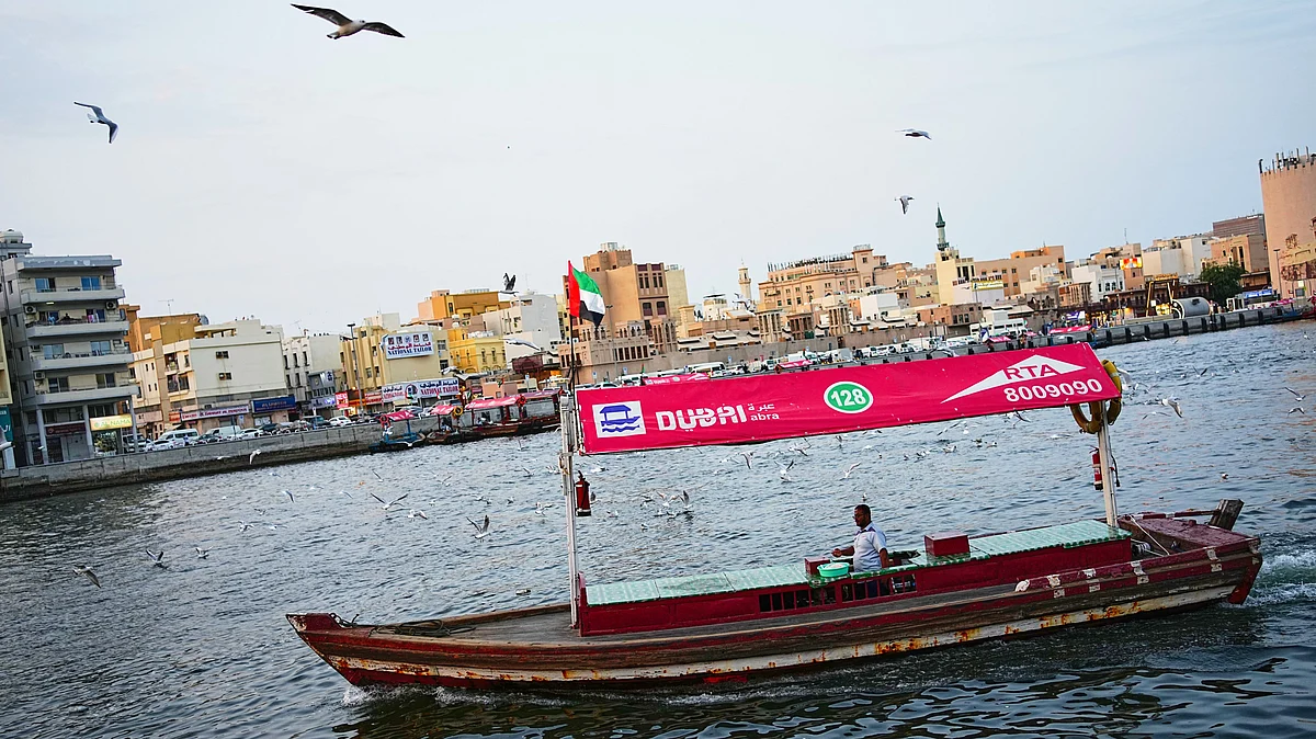 An empty tourist boat in Dubai Creek next to Al Seef market, one of Dubai's busiest tourist areas, 13 Mar