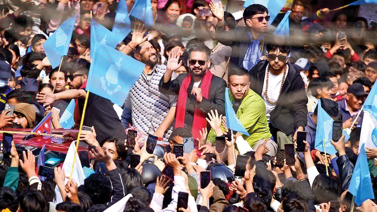 Victorious Balendra Shah and RSP chairman Rabi Lamichhane wave to supporters