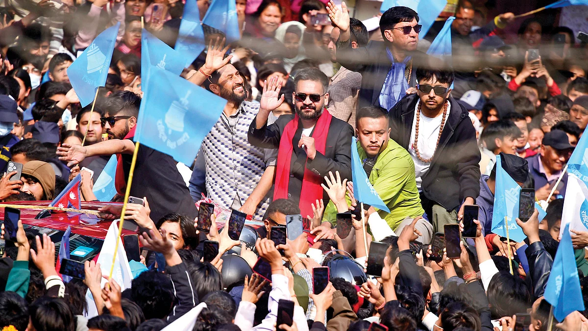 Victorious Balendra Shah and RSP chairman Rabi Lamichhane wave to supporters