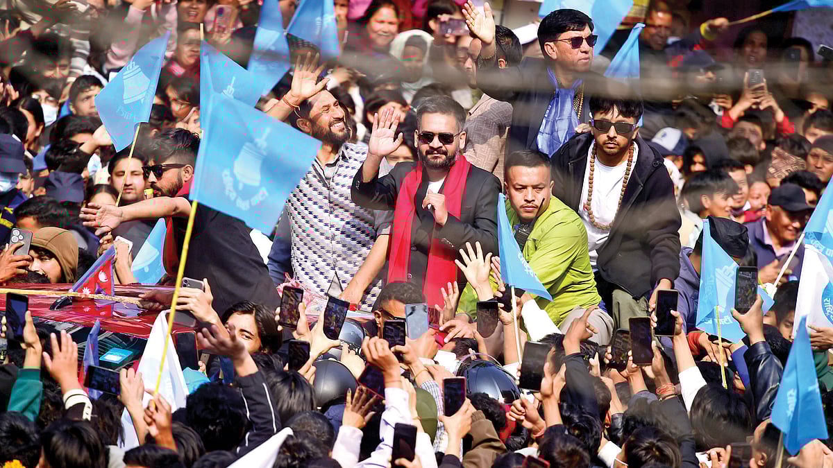 Victorious Balendra Shah and RSP chairman Rabi Lamichhane wave to supporters