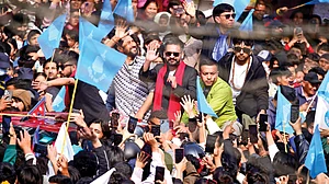 Victorious Balendra Shah and RSP chairman Rabi Lamichhane wave to supporters