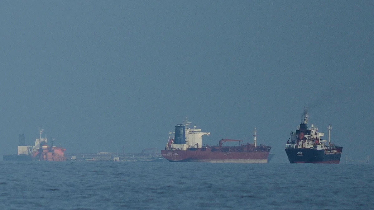 Oil tankers and cargo ships line up in the Strait of Hormuz as seen from Mina Al Fajer, UAE.
