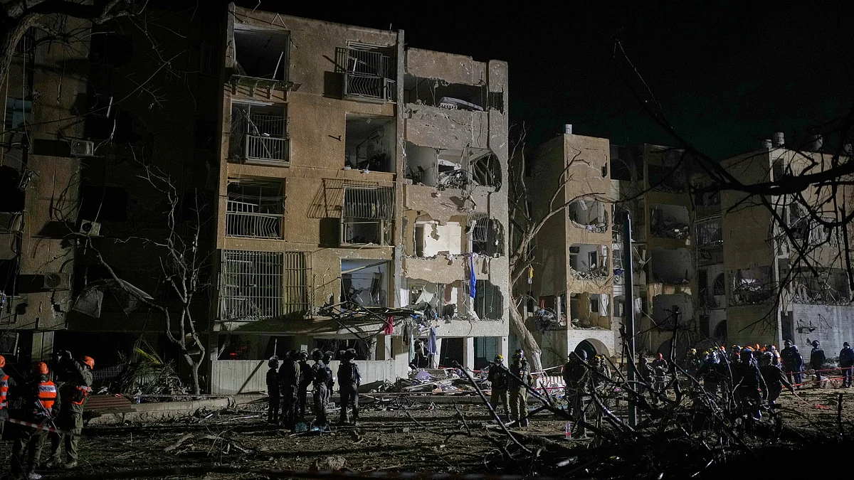 Israeli security forces and rescue teams at the missile strike site in Arad.