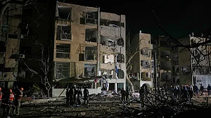 Israeli security forces and rescue teams at the missile strike site in Arad.