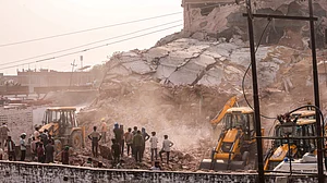 Rescue teams search through debris at the cold storage collapse site in Prayagraj.