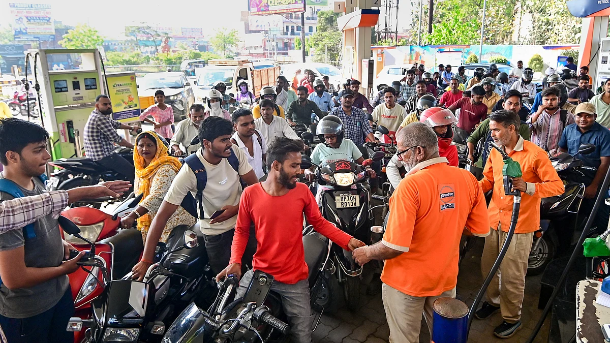 People queue up at a petrol pump amid reports of a fuel shortage in Guwahati