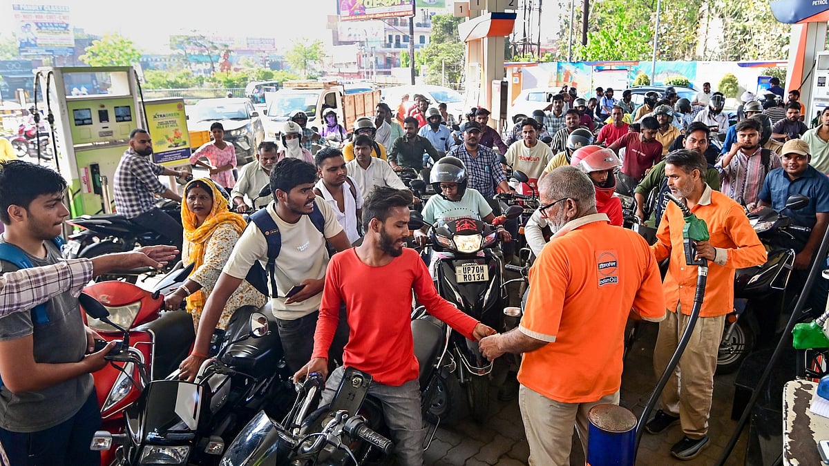 People queue up at a petrol pump amid reports of a fuel shortage in Guwahati