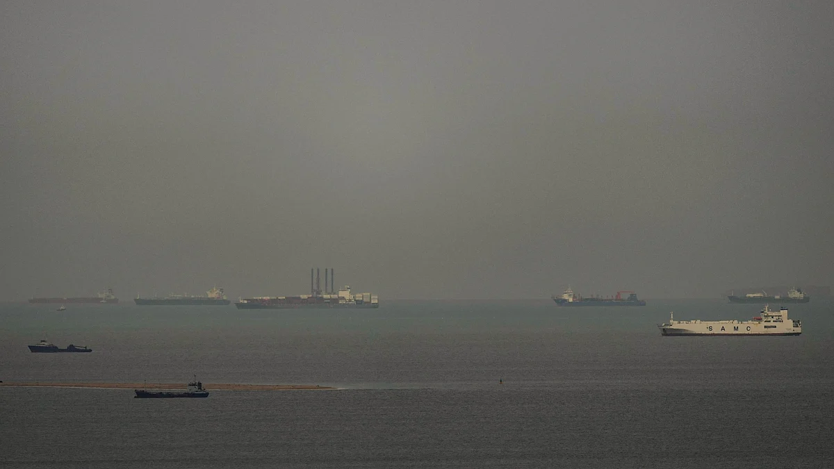 Cargo ships sail through the Arabian Gulf as seen from Ajman, UAE, 27 March 