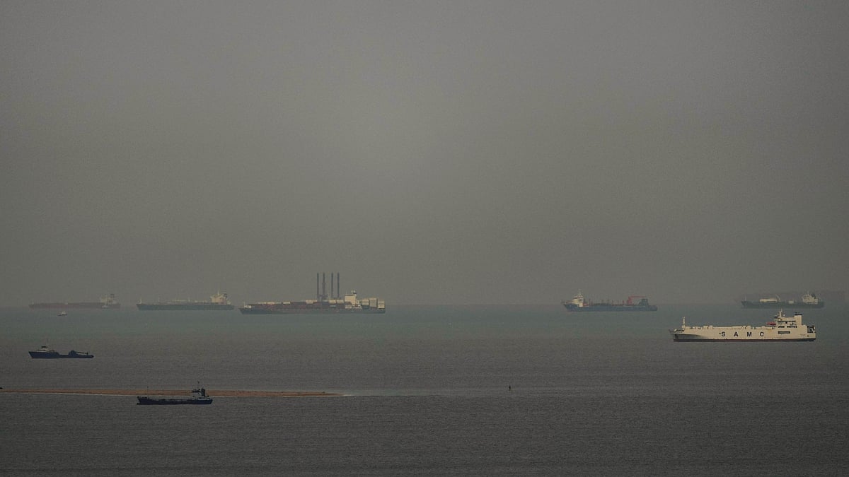 Cargo ships sail through the Arabian Gulf as seen from Ajman, UAE, 27 March 