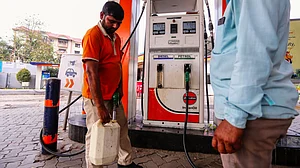A worker fills a container at a petrol pump amid fuel shortage in Prayagraj, Uttar Pradesh, 27 March