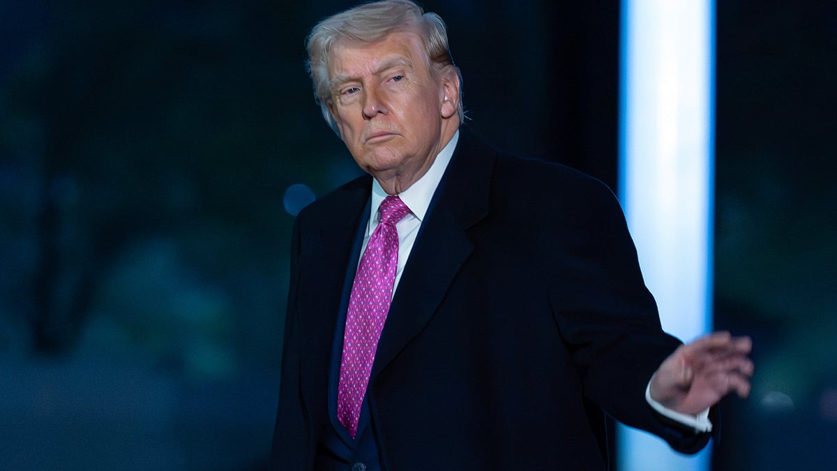 Donald Trump walks across the South Lawn after arriving at the White House.