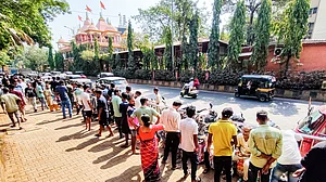People wait with empty LPG cylinders in Navi Mumbai, 30 March