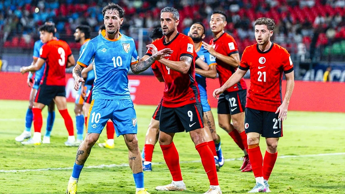 Ryan Williams (in blue) takes position during a corner kick against Hong Kong