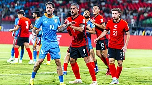 Ryan Williams (in blue) takes position during a corner kick against Hong Kong