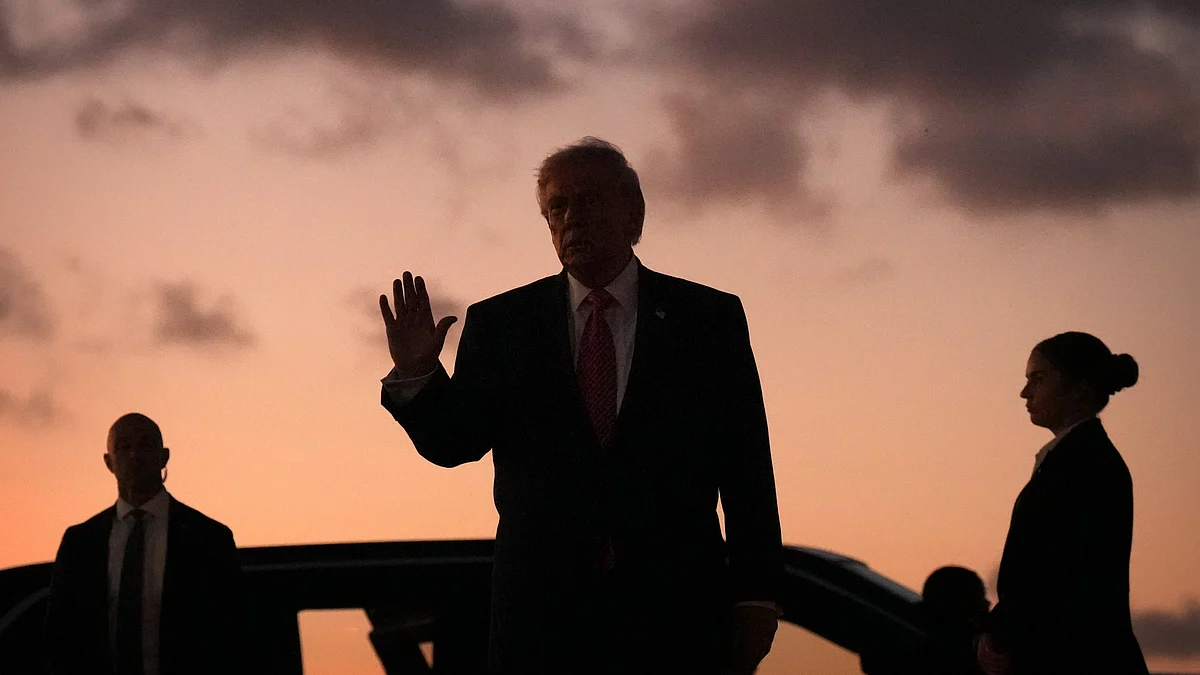 Donald Trump waves after stepping off Air Force One.