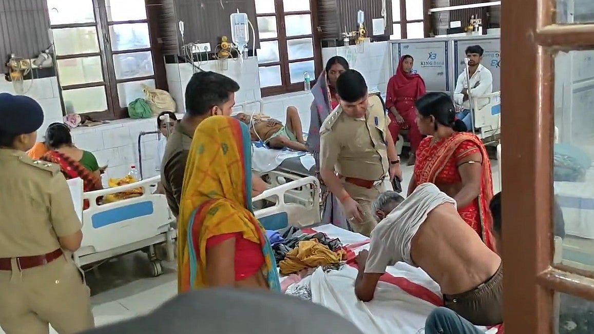 Policemen question patients inside a hospital ward amid the investigation.