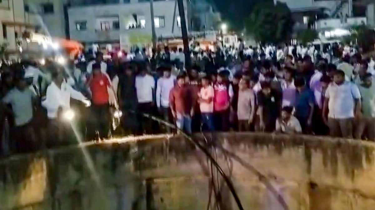 People gather around a well after a car fell into it killing nine people. 