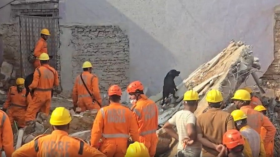 NDRF teams carry out rescue operations at the collapse site.