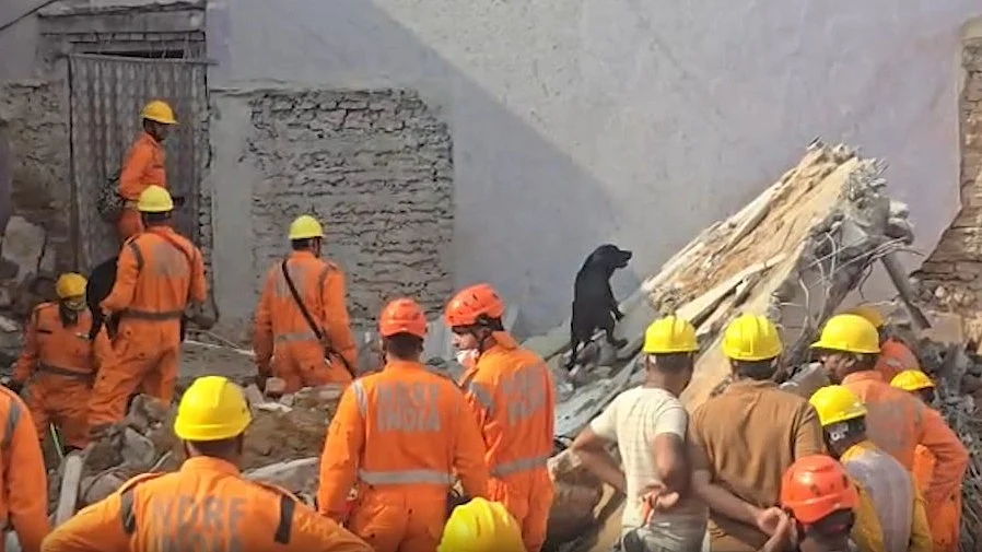 NDRF teams carry out rescue operations at the collapse site.