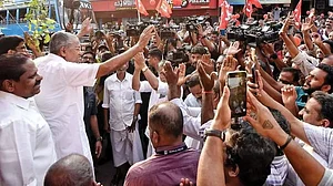 Chief minister Pinarayi Vijayan with party workers at a roadshow in Kannur