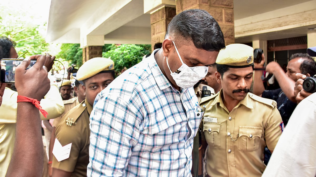Police escort a convict outside a court premises in connection with the Sathankulam custodial death case.