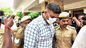 Police escort a convict outside a court premises in connection with the Sathankulam custodial death case.