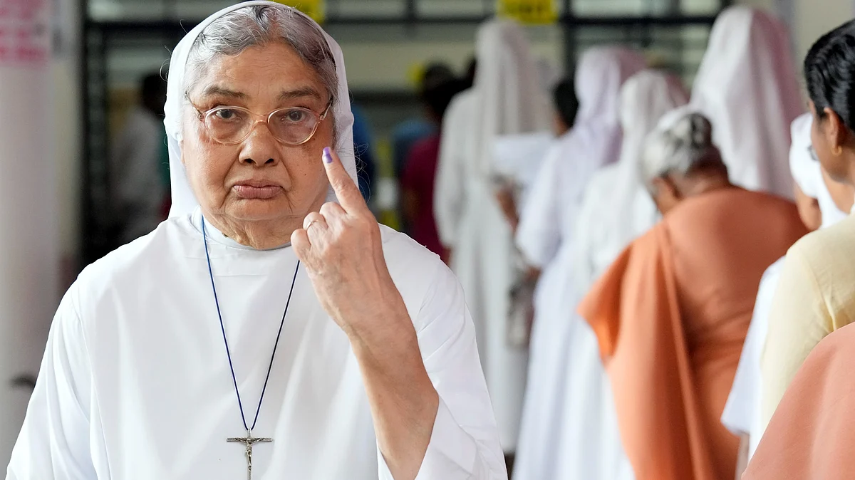 A nun shows her ink-marked finger after casting vote during Puducherry Assembly elections.