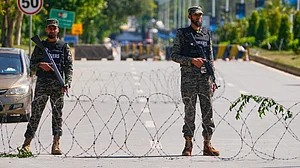 Soldiers stand guard at a checkpoint ahead of the Iran-US negotiations in Islamabad, 10 April