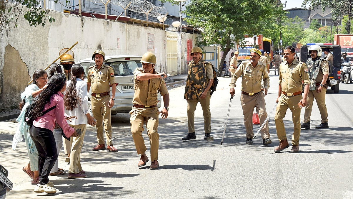 Police personnel resort to a lathi charge on protesters demanding a salary hike in Noida.