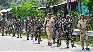 Police personnel conduct flag march in Jalpaiguri.
