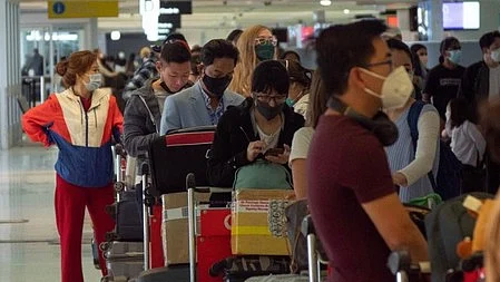 Airline passengers line up at an airport in Australia