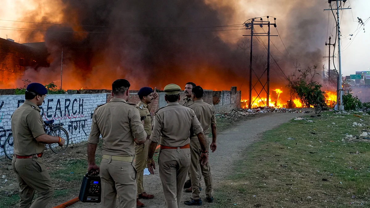 Security personnel at the site after fire guts 200 shanties in Lucknow’s Vikas Nagar.