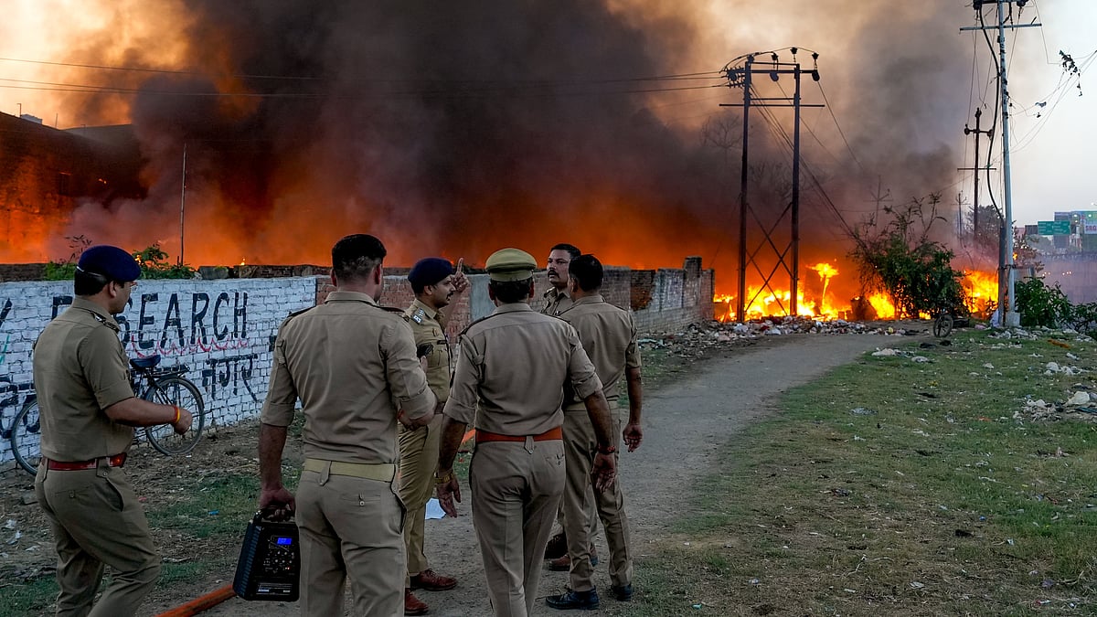 Security personnel at the site after fire guts 200 shanties in Lucknow’s Vikas Nagar.
