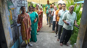 People wait in queues before casting their votes in Nandigram, Purba Medinipur.